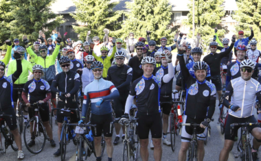 Image is of a large crowd of Cycle for Sight event goers smiling and cheering!