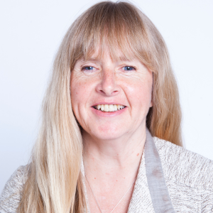 Photo of Diane Bergeron. Diane is in a light-coloured suit jacket and is smiling at the camera. 