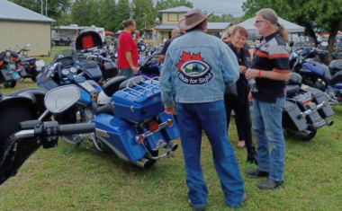 Motorcycles and person wearing a Ride for Sight jacket