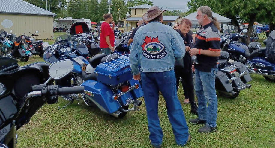 Motorcycles and person wearing a Ride for Sight jacket