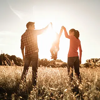 family playing in a field